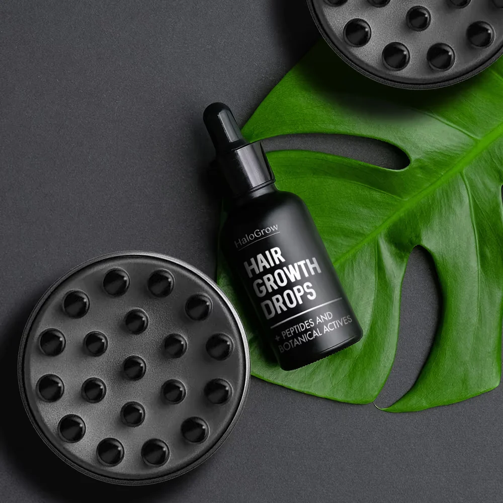 HaloGrow Hair Spray bottle on a leaf